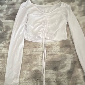 Very cropped, long sleeve.